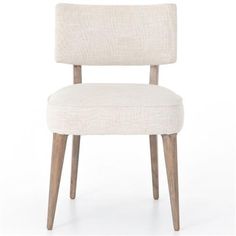 an upholstered chair with wooden legs and a white fabric seat pad on the back