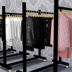 the clothing rack is full of clothes and has gold trimmings on each side