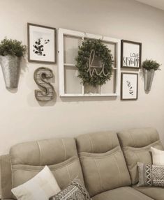 a living room filled with furniture and pictures on the wall