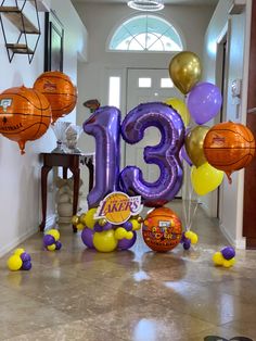 balloons and basketballs are on the floor in front of an entrance