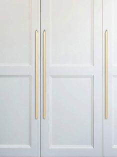 two white doors with gold handles on them