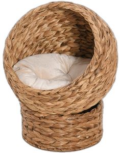 a dog bed made out of wicker with a white pillow in the middle and inside