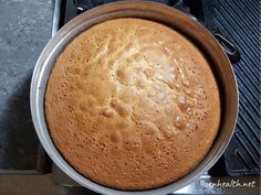 a cake in a pan sitting on top of a stove