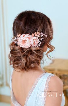 a woman with flowers in her hair is wearing a white dress and has long brown hair