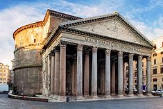 an old building with many pillars in front of it