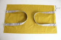 a piece of yellow fabric with silver trim