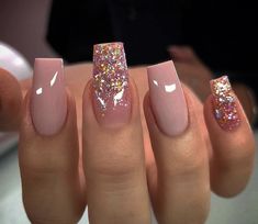 a woman with pink and gold nail polish on her nails