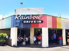 people are standing outside the rainbow drive - in