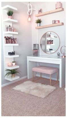 a white desk with a mirror and shelves on it in front of a pink rug