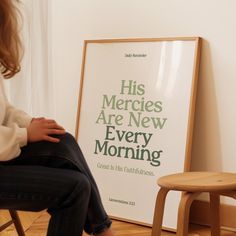 a woman sitting on a chair in front of a poster that reads his mercies are new every morning