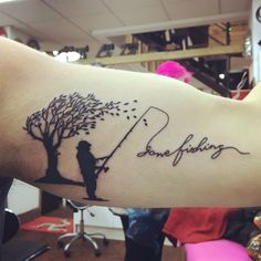 a person with a tree on their arm that has the words love fishing written on it