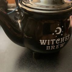 a black teapot sitting on top of a table