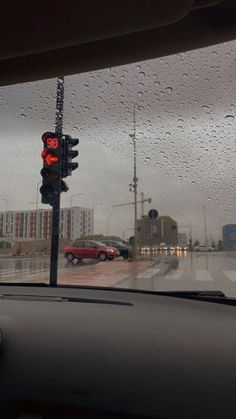 a red traffic light sitting on the side of a road