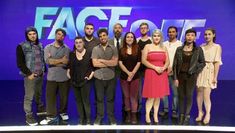 a group of people standing in front of a blue screen with the words face out on it