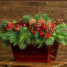 Centerpiece made of noble fir, cedar, and pine with Australian pine cones, red berry clusters, apple/pine cone picks, and a red metallic container Cranberry Centerpiece, Xmas Centerpieces, Fall Thanksgiving Wreaths, Window Wreath, T Craft, Apple Decorations, Red Wreath, Christmas Centerpieces Diy, Pine Cone Crafts