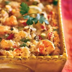 a casserole dish with shrimp and vegetables