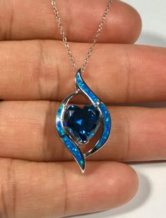 "Brand new high quality solid 925 sterling silver 18\" chain necklace with Blue Inlay Fire Opal and 10mm heart shape Blue Topaz stone. The sliding pendant measures 1-1/8\" long and 5/8\" wide. Our silver is genuine solid 925 sterling silver and rhodium plated for better quality and prolonged shine, and stamped 925. You will receive the item in a gift box Thanks for looking and check out more items in my Etsy shop for more great items and deals! https://www.etsy.com/shop/925usa Payment: We accept Sapphire Sterling Silver Heart Pendant Necklace, Sterling Silver Heart Cut Sapphire Necklaces, Sterling Silver Sapphire Heart Cut Necklaces, Sapphire Heart Pendant Necklace In Sterling Silver, Heart Cut Sapphire Sterling Silver Necklaces, Sapphire Heart Sterling Silver Necklace, Sapphire Heart Necklace In Sterling Silver, Heart-shaped Sapphire Necklace In Sterling Silver, Blue Heart Cut Jewelry For Gift