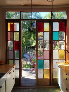 an open kitchen door with colorful glass panels