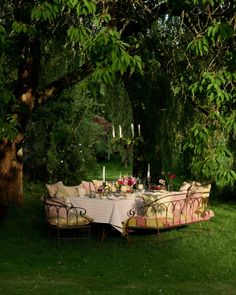 an outdoor dining table set up in the grass