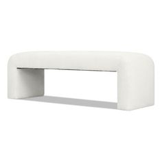 a white bench sitting on top of a white floor