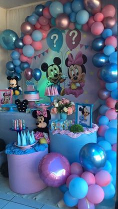 a birthday party with balloons and mickey mouse decorations