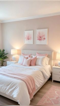 a white bed sitting in a bedroom next to two lamps and a pink rug on top of a hard wood floor