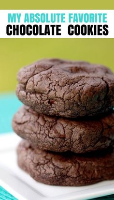 three cookies stacked on top of each other on a white plate with green tablecloth