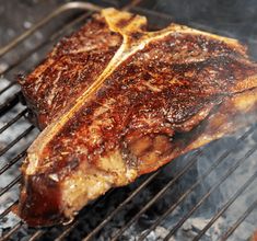 the steak is being cooked on the grill