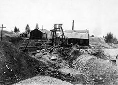 an old black and white photo of a building on top of a hill in the middle of nowhere