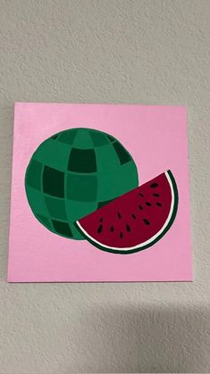 a piece of art with a watermelon slice on it's side and a pink background