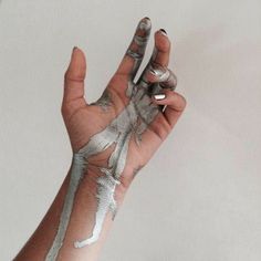 a person's hand with white paint on it