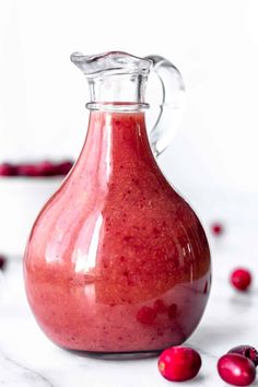 a glass pitcher filled with cranberry sauce