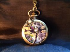 A gorgeous pendant watch necklace in Art Nouveau style, with a large dragonfly on the jump lid, with beautifully painted wings, and the body decorated with glass jewels.  This Vintage  style pocket watch will make a darling gift for women who love nostalgic jewelry, and is also a beautiful gift for bridesmaids, and an heirloom to keep, for Christmas, New Year, Valentines Day, Birthday, Wedding, Easter... This romantic pendant watch is an original by ANNALEAS FINEST. This watch is also a great gift for dragonfly lovers and the back has fine floral Victorian flower patterns.  Inside, there is a lovely retro image with flowers and dragonflies, and delicate hands show the time.  The Battery can be exchanged by opening the back.  This watch is stable and has a very pleasant weight. Pendant watc Gold Handmade Pocket Watch For Gift, Handmade Gold Pocket Watch For Gift, Dragonfly Art Nouveau, Painted Wings, Elf Jewelry, Mushroom Ring, Pendant Watch, Pocket Watch Necklace, Dragonfly Art