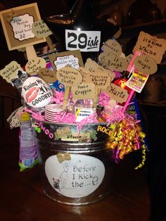 a bucket filled with lots of different types of items on top of a wooden table