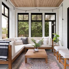 a living room filled with furniture and lots of windows