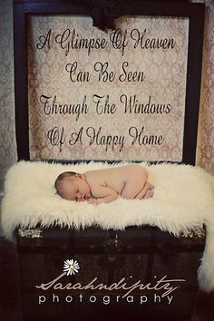 a baby is laying on top of a suitcase with the words, a glimpse of heaven can be seen through the windows of a happy home