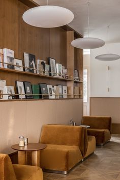 two brown chairs sitting next to each other in a room