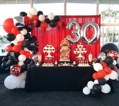 a table with balloons and decorations on it