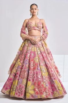 Coffee attached can-can lehenga features bright floral applique motifs along with the sprinkling of sequin and crystals. Paired with strappy, padded blouse and dupatta are full embroidered. 
Component: 3
Pattern: Embroidered
Type Of Work: Floral
Neckline: Sweetheart
Sleeve Type: Sleeveless
Fabric: Net
Color: Brown
Other Details: 
Floral embroidery
Tassel hem blouse
Attached can-can lehenga
Embroidered dupatta
Occasion: Wedding,Bride - Aza Fashions Strappy Blouse, Seema Gujral, Floral Lehenga, Outfits Indian, Net Lehenga, Red Lehenga, Embroidered Lehenga, Party Wear Indian Dresses, Chaniya Choli