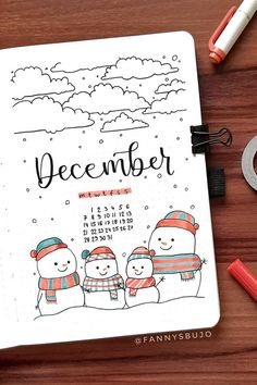 a calendar with three snowmen on it next to markers, pens and markers