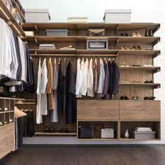 an organized closet with clothes and shoes on the shelves, along with other clothing items