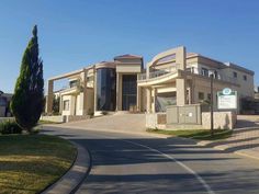 an empty street in front of a large house