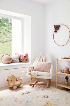 a child's room with white walls and furniture