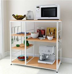 a microwave oven sitting on top of a wooden shelf