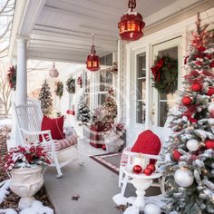 a porch decorated for christmas with red and white decorations