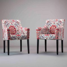 two chairs sitting side by side in front of a gray background with red and blue designs on them