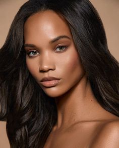 a beautiful woman with long hair posing for the camera and looking at the camera while wearing a bra