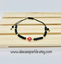 The post is for one individual bracelet. This beautifully handmade bracelet is made of 4mm black rondelle crystal beads, small gold beads with a turkish glass eye bead that is 6mm. They are made with red nylon string and are adjustable to fit most wrists as it has a sliding knot to adjust. These are a great accessory for everyday wear. This bracelet is great for spiritual and evil eye purposes. It is believed that when a person wears or carries an evil eye with them, it guards against misfortune Black Evil Eye Bracelet With 8mm Beads For Gift, Black Evil Eye Bracelet With 8mm Beads As Gift, Black Spiritual Evil Eye Bracelet With Round Beads, Spiritual Black Evil Eye Bracelet With Round Beads, Black Evil Eye Bracelet With Round Beads As Gift, Spiritual Evil Eye Bracelet With Black Beads For Gift, Adjustable Rondelle Crystal Bracelet With 8mm Beads, Black Evil Eye Round Beads Jewelry, Black Adjustable Rondelle Beaded Bracelets