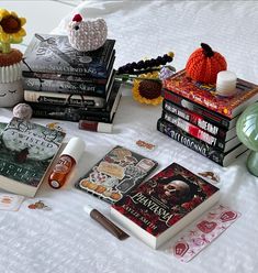 a table topped with books and knick - knacks on top of a bed