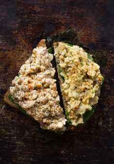 two pieces of bread that have some food on top of it, one half eaten